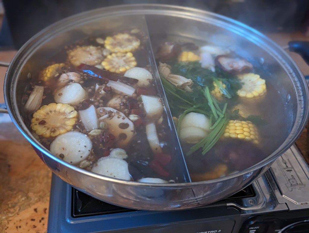 Hotpot with Sichuan and mushroom broth in a yin yang pot