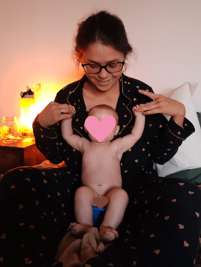 Baby sitting on a top hat potty as part of early potty training.